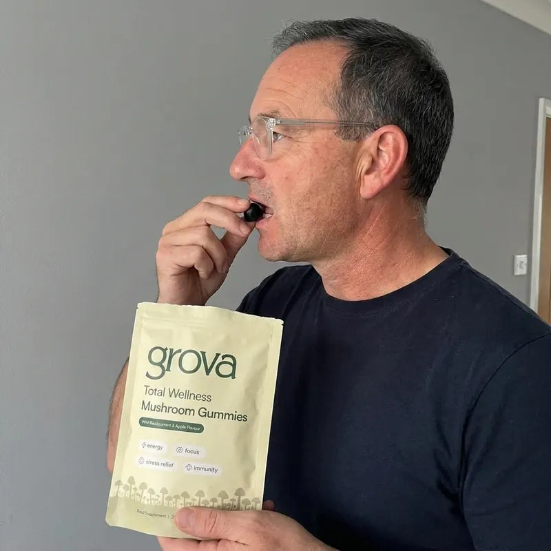 Man taking a Grova mushroom gummy