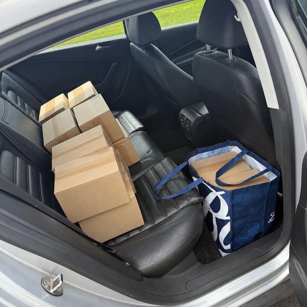Early Grova parcels ready for a post-office run, stacked on a car seat.