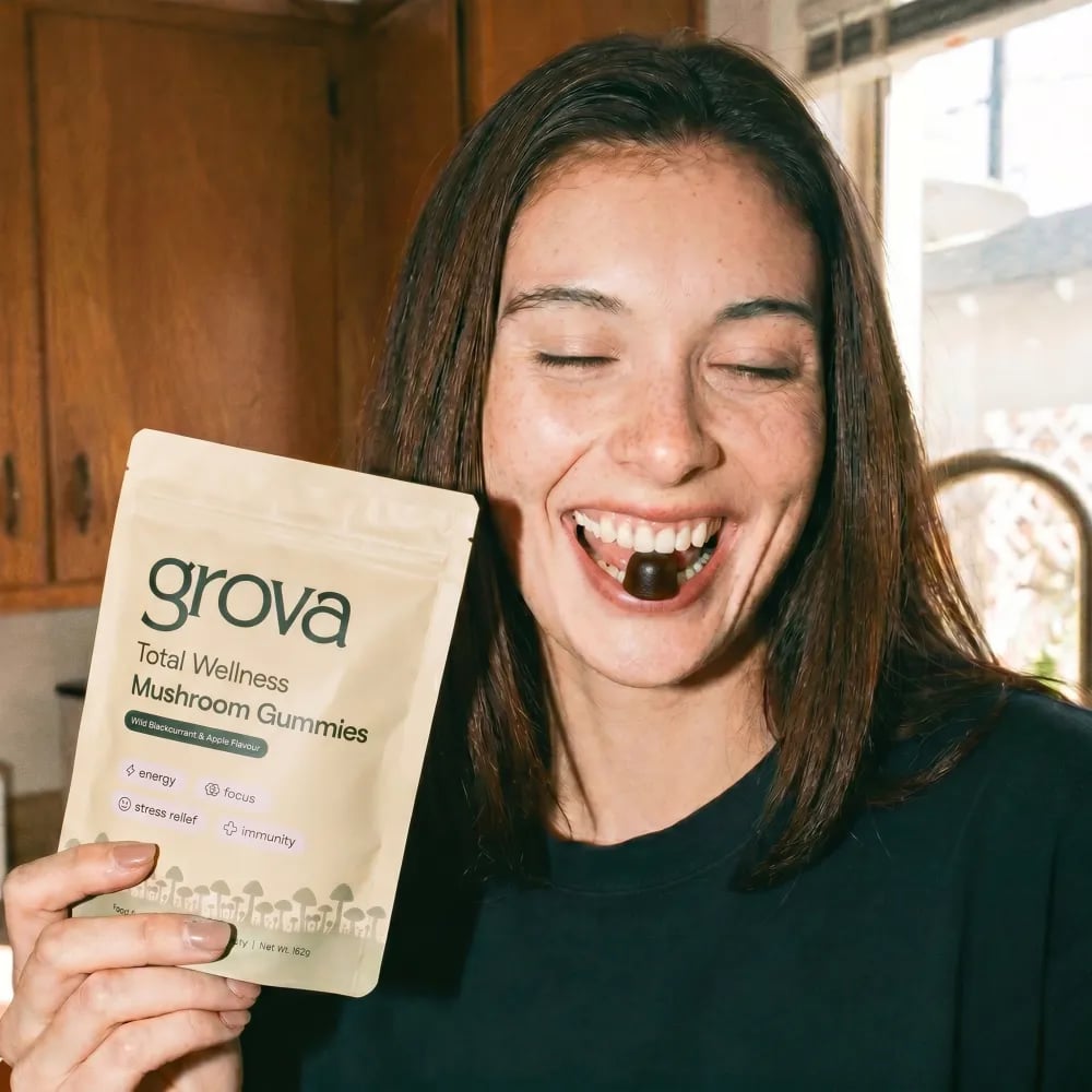 Grova mushroom gummies being poured into a hand